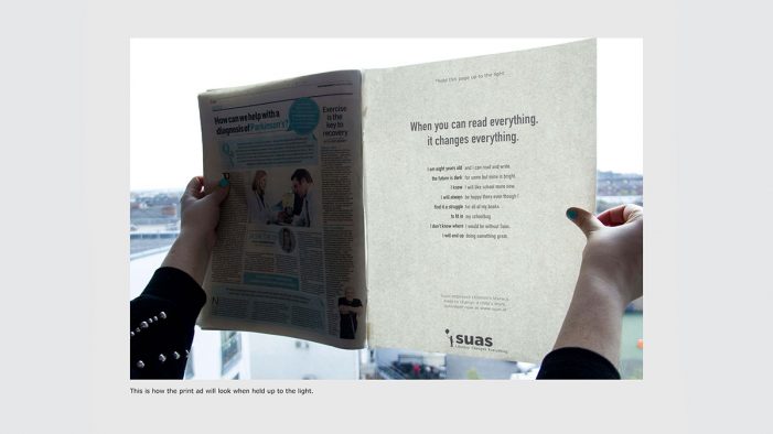 Invisible Newspaper Print Revealed by Light Shows How Literacy Can Change Everything