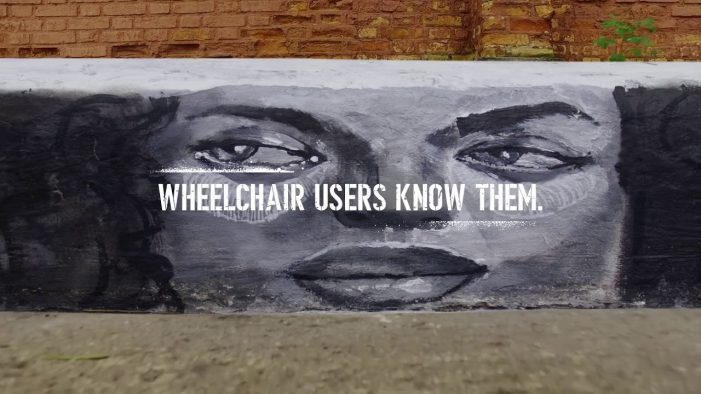 Graffiti art shows that sidewalk curbs without ramps become walls for wheelchair users