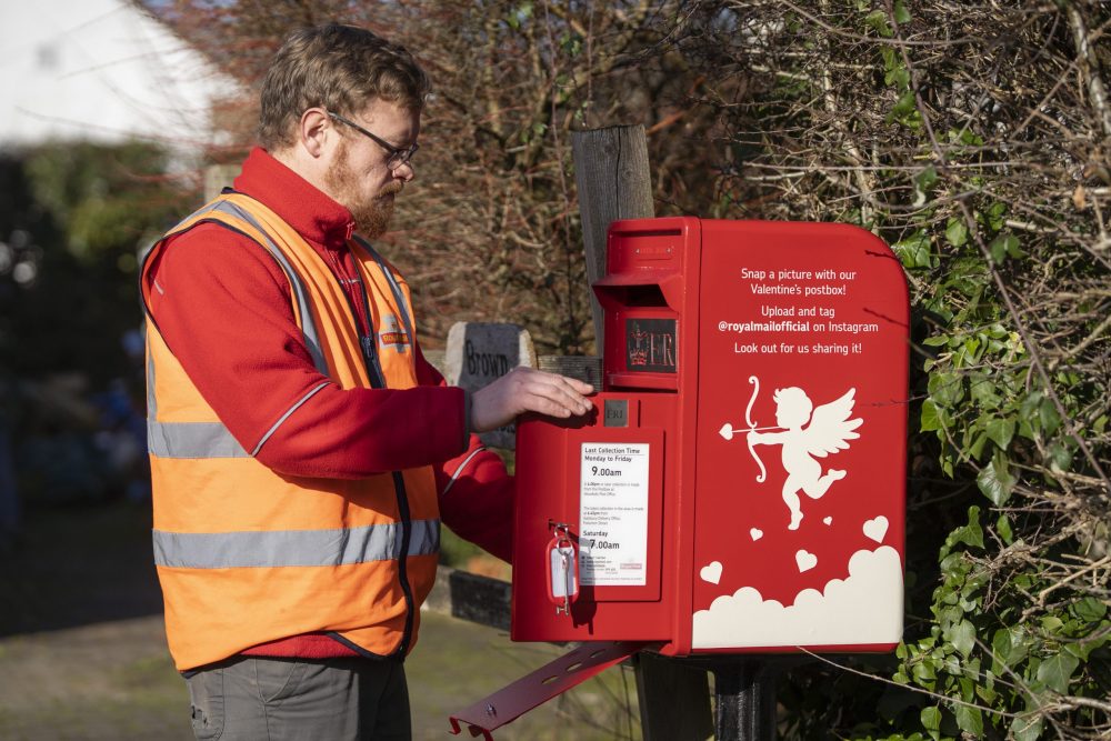 Postman Dan Bennett collecting the mail in Lover, Wiltshire.